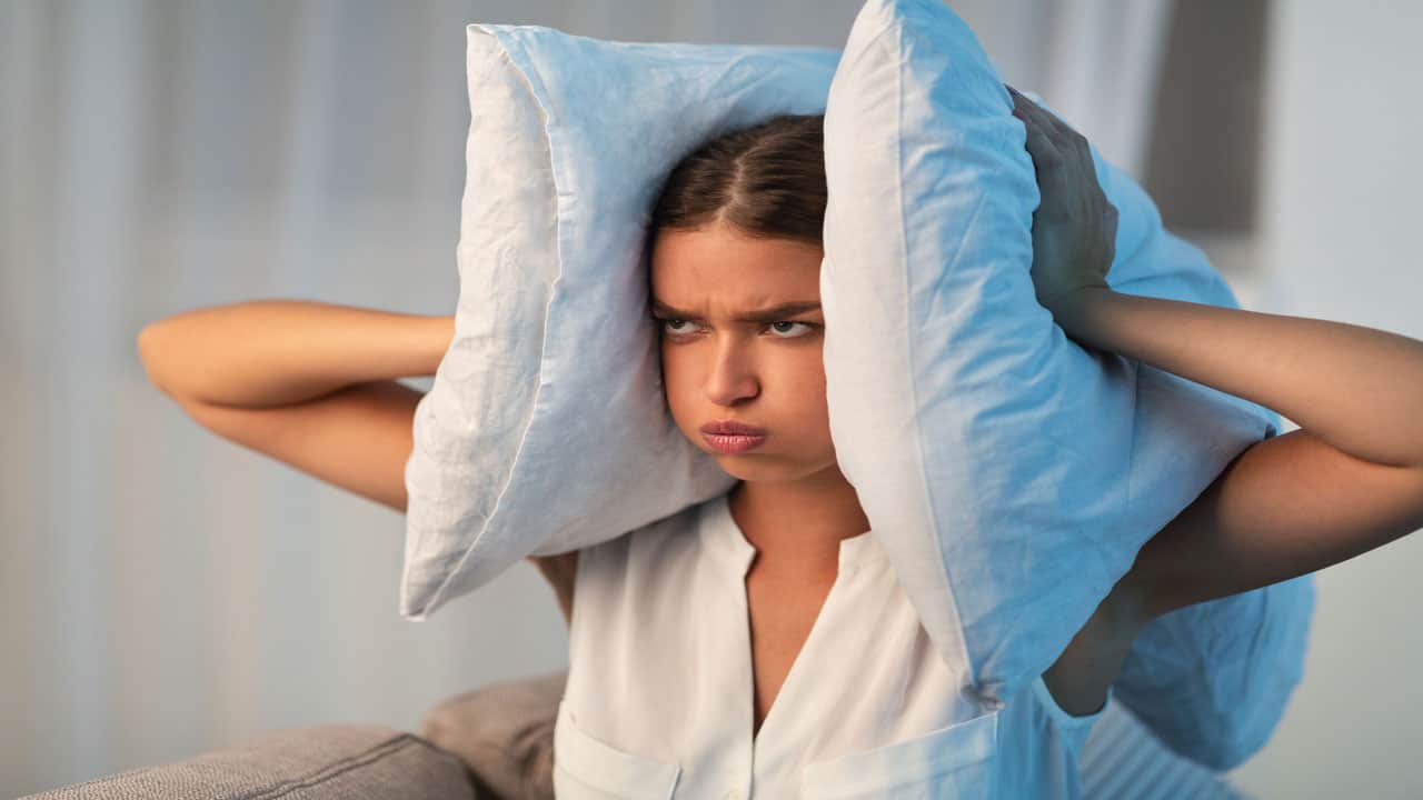annoyed girl covering ears