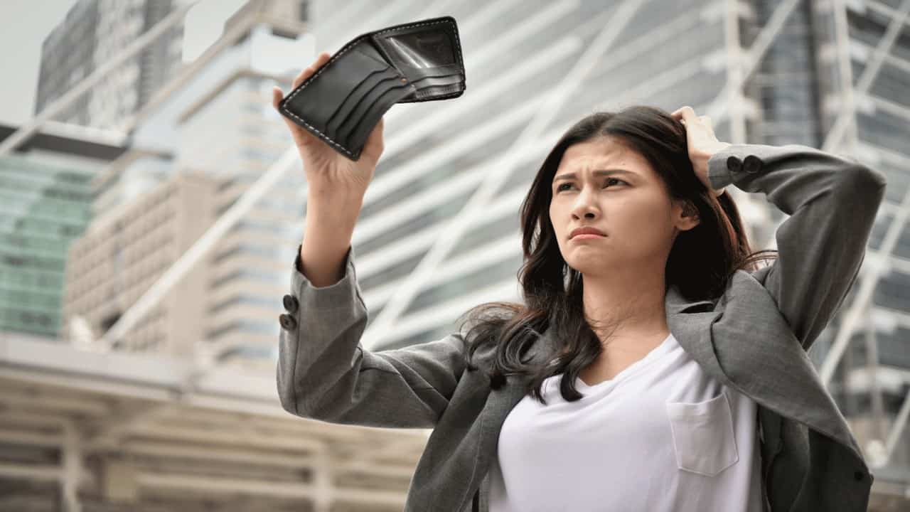 broke woman scratching head