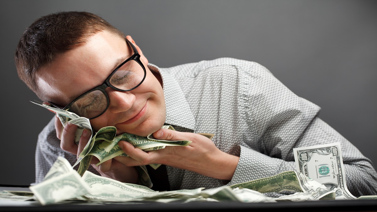 man snuggling money