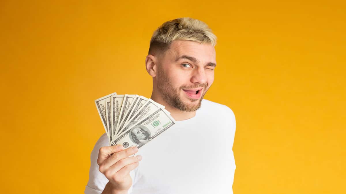man-winking-with-money