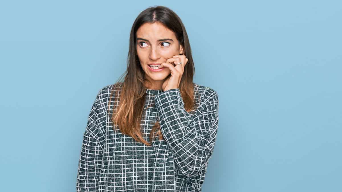 stressed out woman biting fingernails